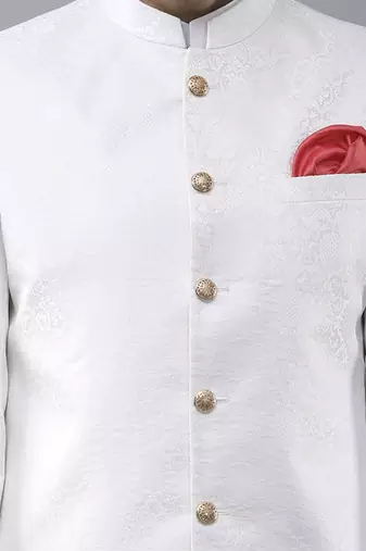 White brocade solid sherwani paired with kurta & churidaar