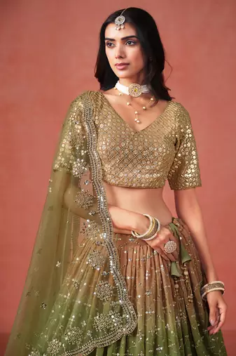 Delightful gradient from warm beige to deep mehndi green sequins zari embroidered georgette indian lehenga