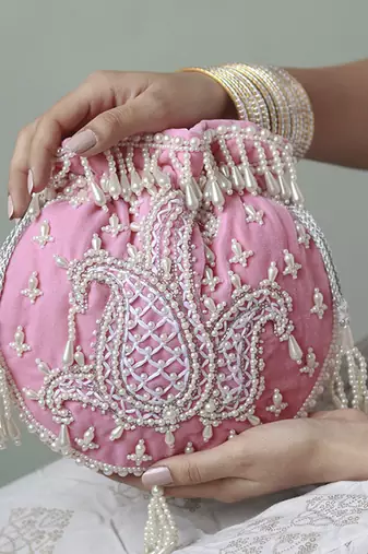 Pink suede hand embroidered potli with pearl handle