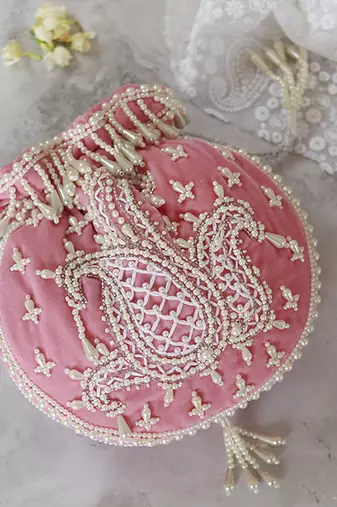 Pink suede hand embroidered potli with pearl handle