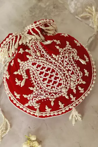 Red suede hand embroidered potli with pearl handle