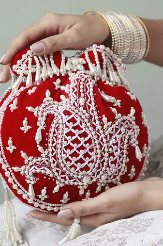 Red suede hand embroidered potli with pearl handle