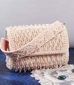 Pink suede clutch bag with a detachable pearl handle