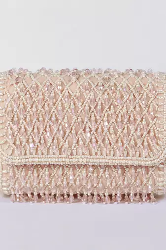 Pink suede clutch bag with a detachable pearl handle