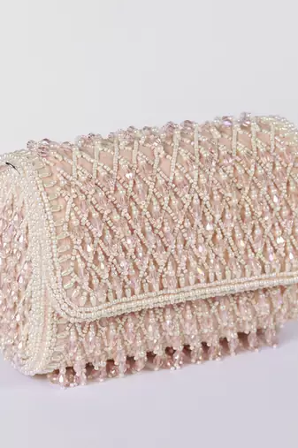 Pink suede clutch bag with a detachable pearl handle