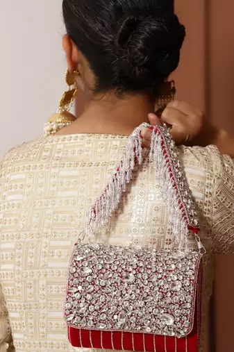 Red suede embellished clutch bag