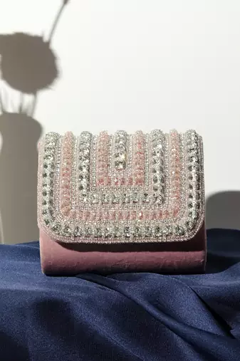 Pink suede mini bag with embroidered handle