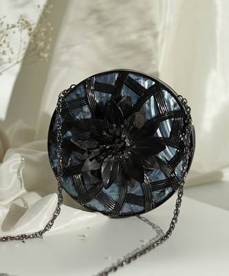 Black intricate brass work pearl clutch 1