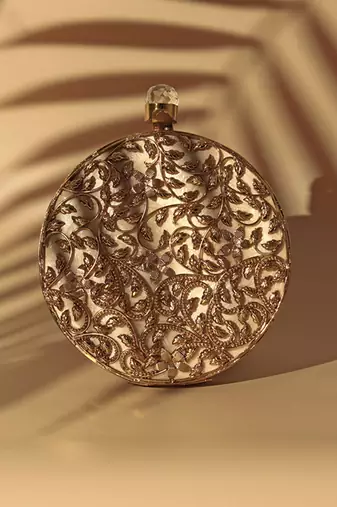 Gold intricate brass work pearl clutch