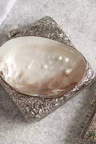 Silver clutch handcrafted with intricate detailing