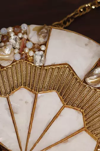 Embellished golden brass clutch