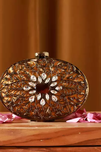 Gold embellished brass clutch with inticrate work