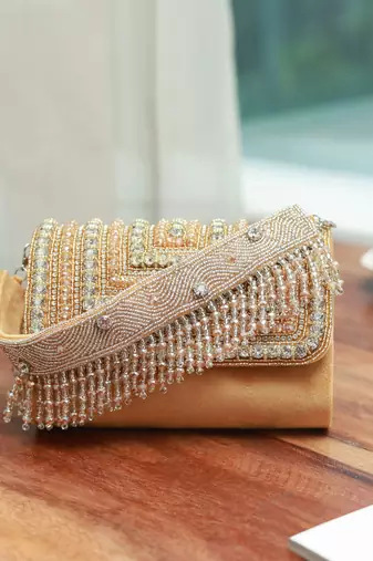 Gold suede embellished flap over clutch bag