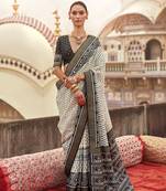 Off white poly viscose silk ikkat printed patola saree with black  weaving  border