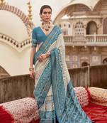 Off white poly viscose silk ikkat printed patola saree with sea blue weaving  border