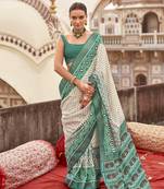 Off white poly viscose silk ikkat printed patola saree with teal weaving  border