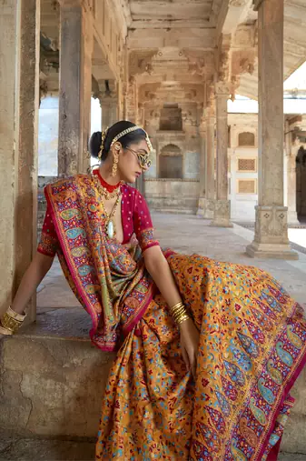 Orange poly viscose silk floral printed pashmina saree with paisley design border