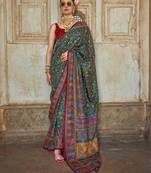Dark green poly viscose silk floral printed pashmina saree with paisley design border