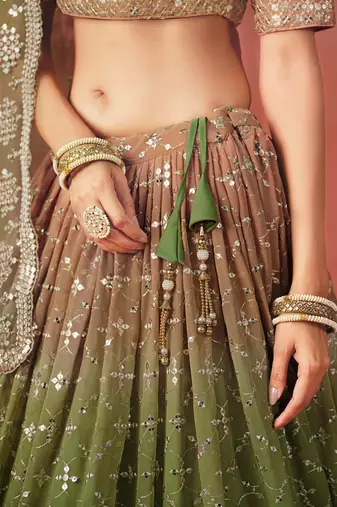 Delightful gradient from warm beige to deep mehndi green sequins zari embroidered georgette indian lehenga