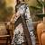 Women's black silk cotton printed saree with unstitched blouse piece