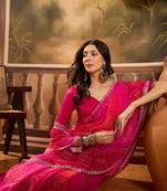 Women's pink georgette bandhni saree with unstitched blouse piece
