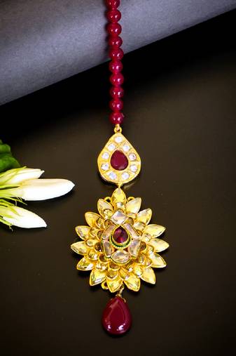 Luxurious floral kundan maang tikka with ruby accents