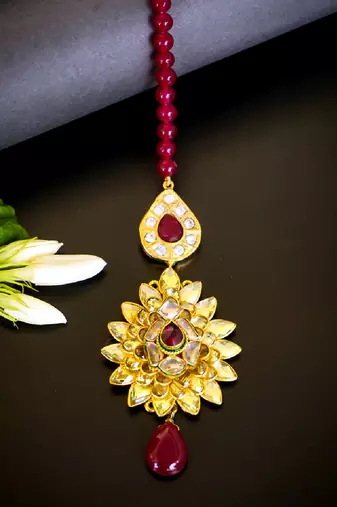 Luxurious floral kundan maang tikka with ruby accents