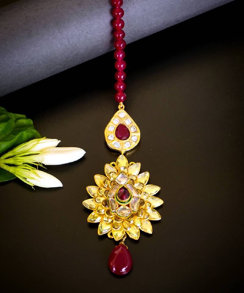 Luxurious floral kundan maang tikka with ruby accents