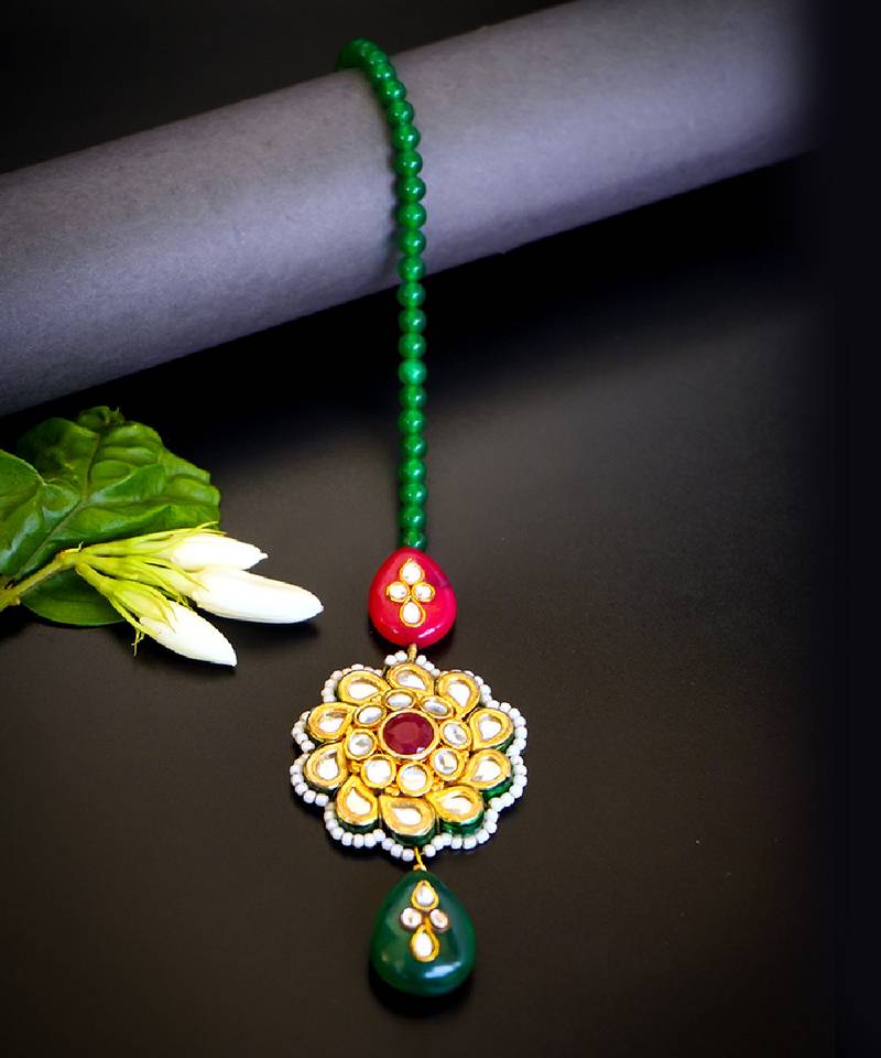 Traditional kundan floral maang tikka with red & green