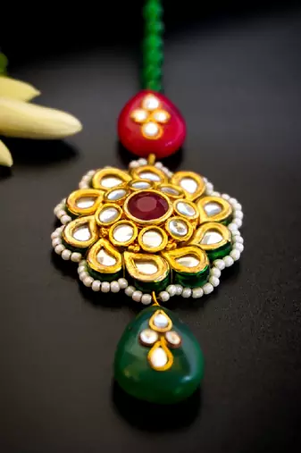 Traditional kundan floral maang tikka with red & green