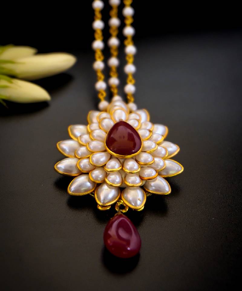   radiant pearl cluster maang tikka with maroon teardrop stone