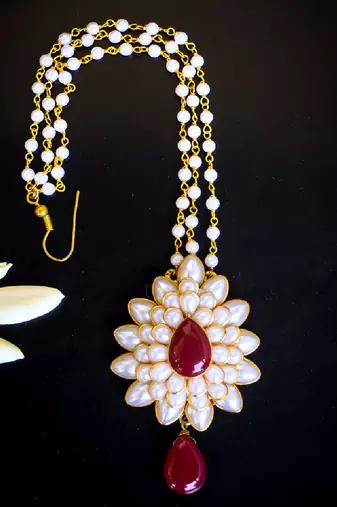   radiant pearl cluster maang tikka with maroon teardrop stone