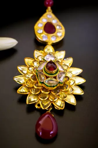 Luxurious floral kundan maang tikka with ruby accents