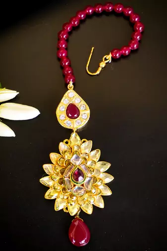 Luxurious floral kundan maang tikka with ruby accents