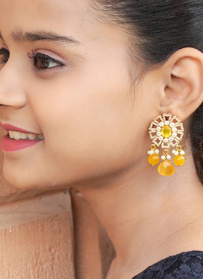 Elegant drop earrings with intricate stone and pearl detailing