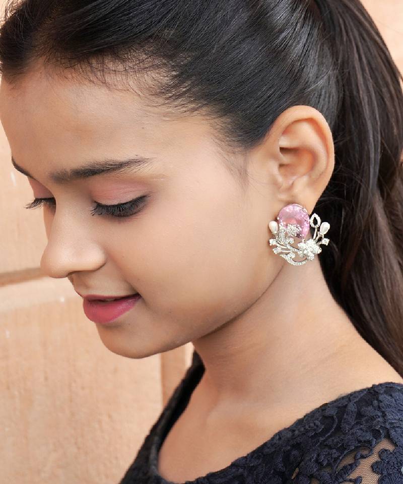 Floral-inspired stud earrings with teardrop centerpiece and pearl accents