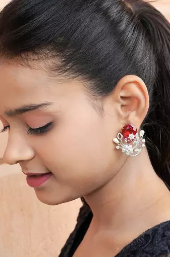 Floral-inspired stud earrings with teardrop centerpiece and pearl accents