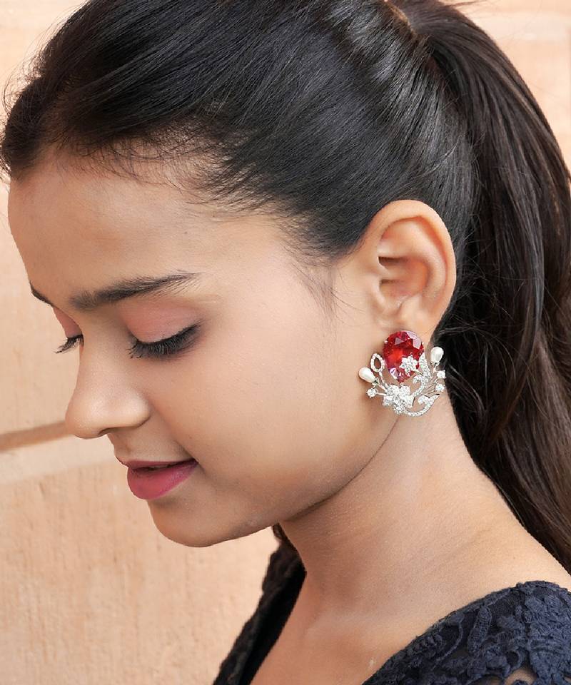 Floral-inspired stud earrings with teardrop centerpiece and pearl accents
