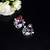Floral-inspired stud earrings with teardrop centerpiece and pearl accents