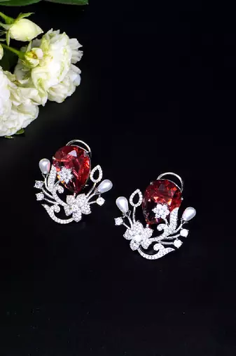 Floral-inspired stud earrings with teardrop centerpiece and pearl accents