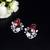 Floral-inspired stud earrings with teardrop centerpiece and pearl accents