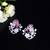 Floral-inspired stud earrings with teardrop centerpiece and pearl accents