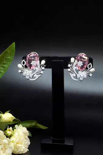 Floral-inspired stud earrings with teardrop centerpiece and pearl accents