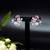 Floral-inspired stud earrings with teardrop centerpiece and pearl accents