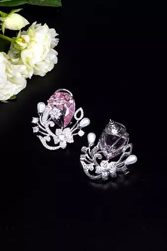 Floral-inspired stud earrings with teardrop centerpiece and pearl accents
