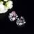 Floral-inspired stud earrings with teardrop centerpiece and pearl accents