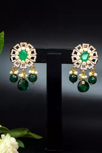 Elegant drop earrings with intricate stone and pearl detailing