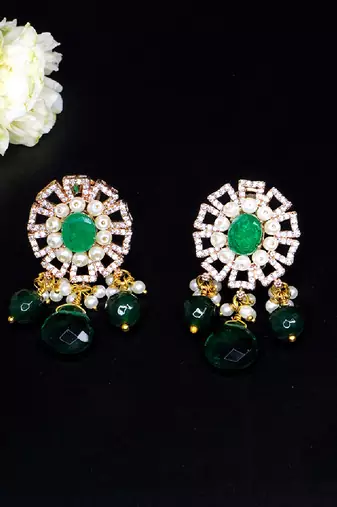 Elegant drop earrings with intricate stone and pearl detailing