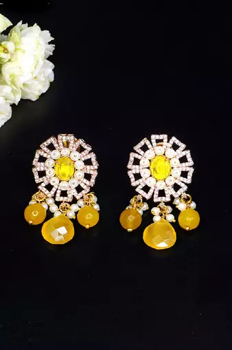 Elegant drop earrings with intricate stone and pearl detailing