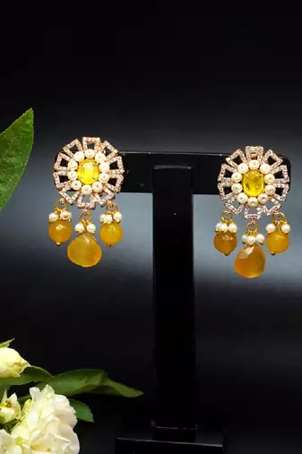 Elegant drop earrings with intricate stone and pearl detailing